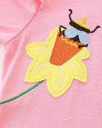 Blush pink kids dress with yellow flower and embroidered insect appliqué, close-up detail view