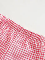 Red and white gingham baby and toddler shorts with elastic waistband, close-up view