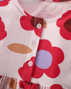 Pink kids floral print dress with white buttons and oversized flower design, front detail view