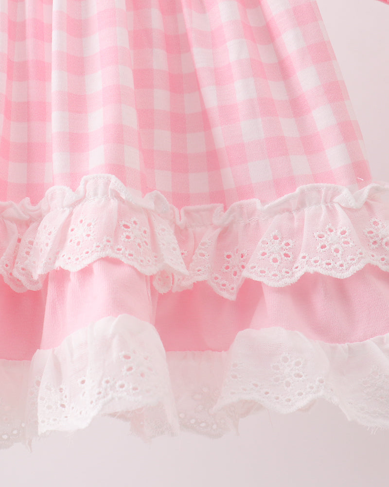 Pink gingham kids dress with layered white eyelet ruffle trim, hem detail view