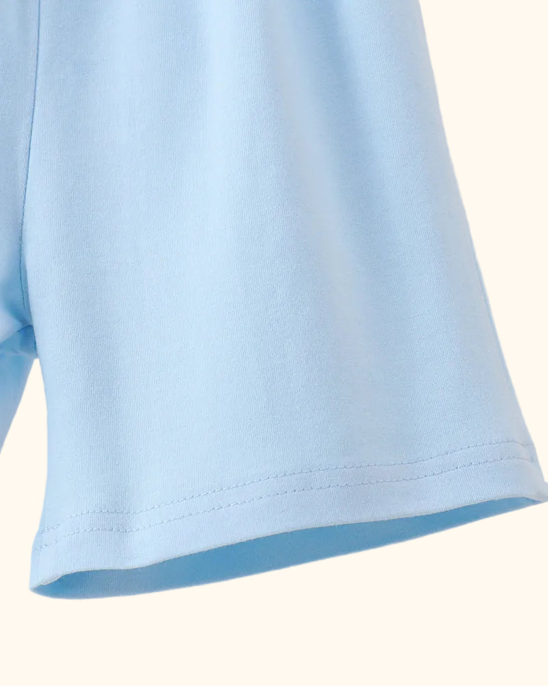 Solid blue kids shorts with clean stitched hem, close-up view
