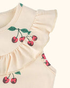 Apricot kids cherry print dress with flutter shoulder and gathered yoke ruffle, close-up view