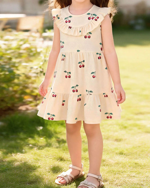 Apricot kids cherry print ruffle dress worn by child, front lifestyle view