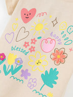 Apricot kids T-shirt with hearts, sun, happy lettering and embroidered flower accents, graphic close-up