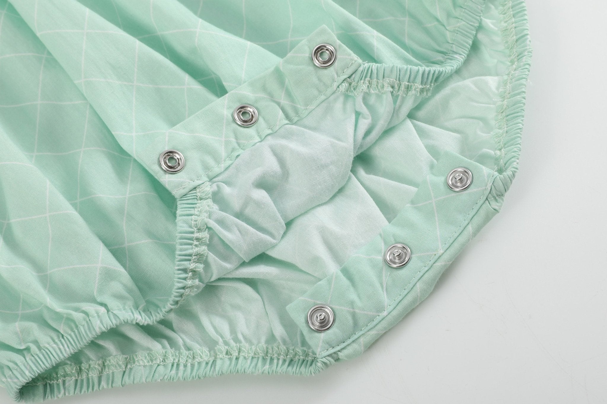 Aqua baby romper with three-snap bottom closure and elasticized leg openings, detail view