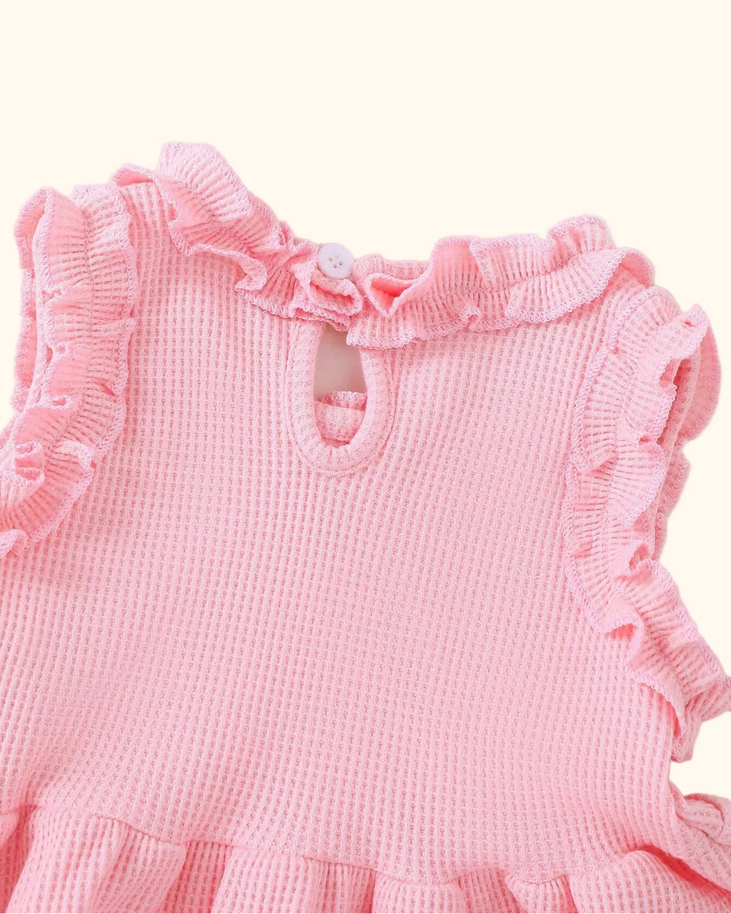 Pink baby waffle knit peplum top with back keyhole opening and button closure, back detail view