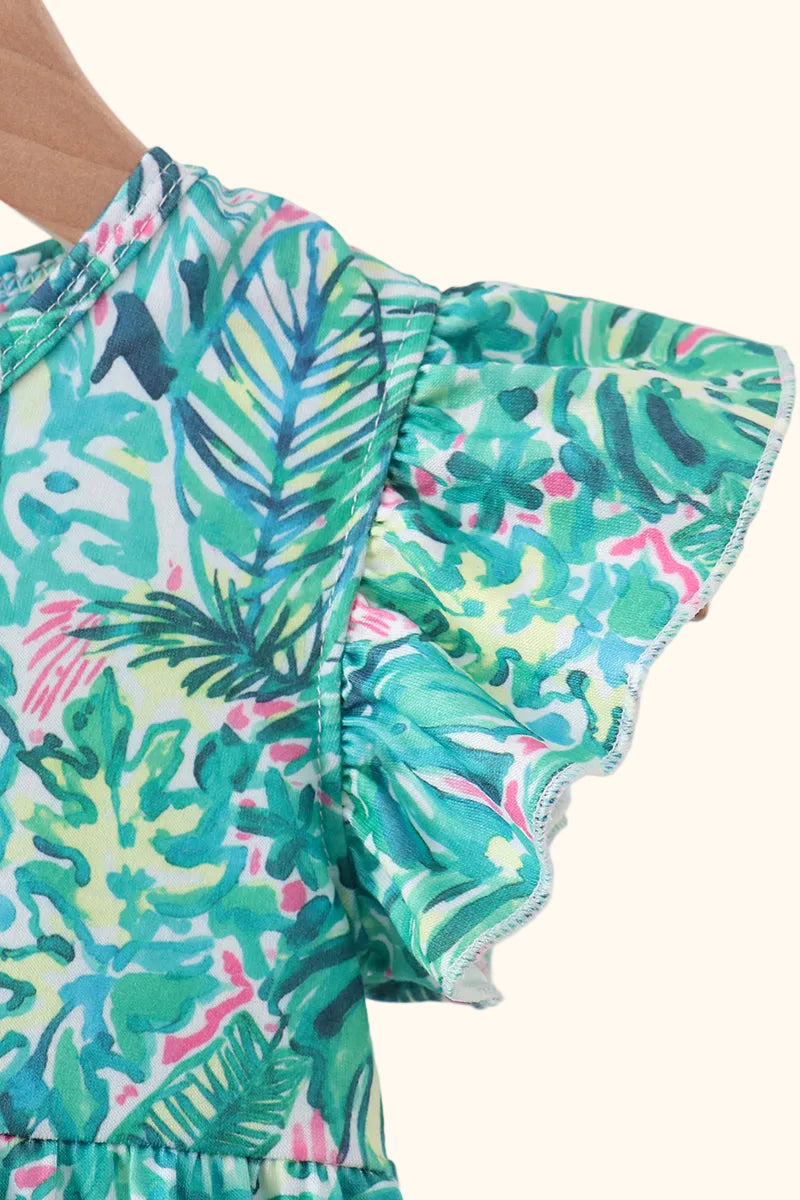 Green botanical baby romper with tropical print and flutter sleeve detail, close-up view