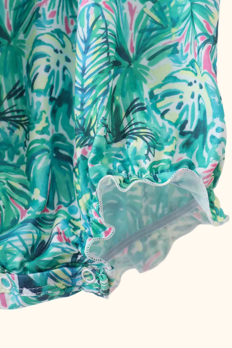 Green tropical floral baby bubble romper with elasticized leg opening, detail view
