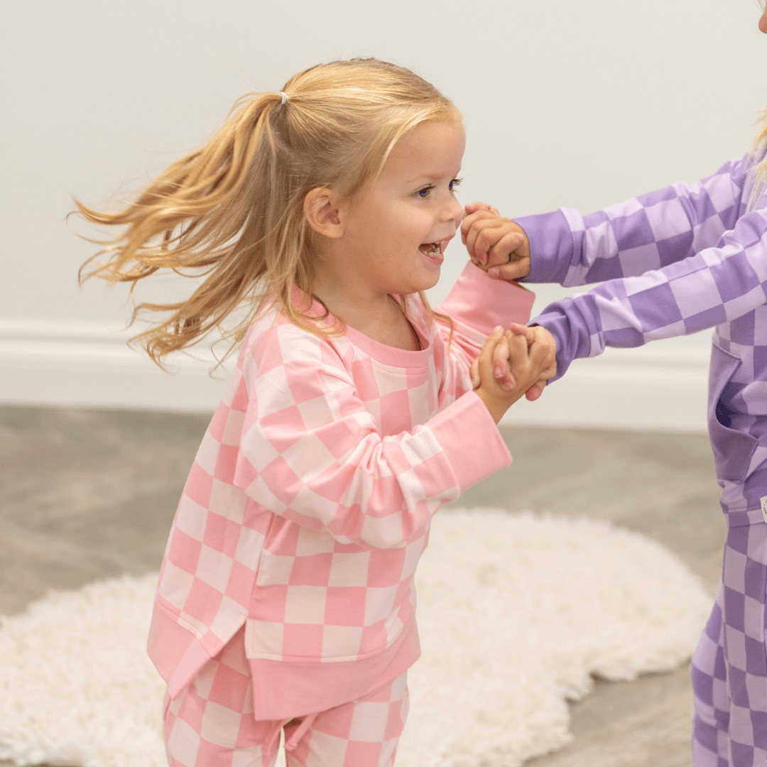 Baby pink and white checker kids crew neck jogger set, front lifestyle view