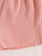 Pink baby cami and shorts set with crinkled textured fabric, fabric close-up
