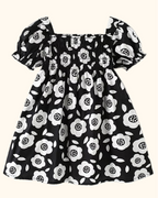 Black kids floral square-neck dress with smocked bodice and puff sleeves, front product view