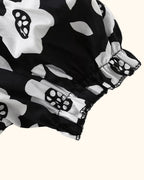 Black floral kids dress with elasticized puff sleeve and ruffled cuff, sleeve close-up