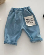 Blue kids tapered trousers with elastic waist and back patch pocket, back view