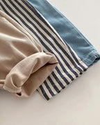 Blue tapered trousers beside khaki and striped styles, color and fabric comparison view