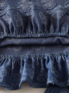 Blue baby flower set with textured tonal floral motifs and gathered ruffle hem, fabric close-up