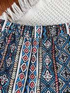 Blue geometric kids wide-leg pants with gathered elastic waistband and pocket, close-up view