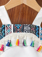 White kids tank with blue geometric print panel and multicolor tassel fringe, neckline close-up