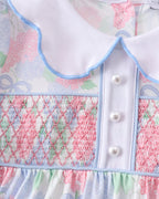 Blue hydrangea smocked dress with pearl buttons and contrast collar, bodice close-up view
