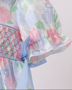 Blue and pink hydrangea kids dress with puff sleeve and blue side tie, detail view