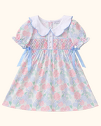 Blue and pink hydrangea kids smocked dress with pearl buttons and Peter Pan collar, front product view