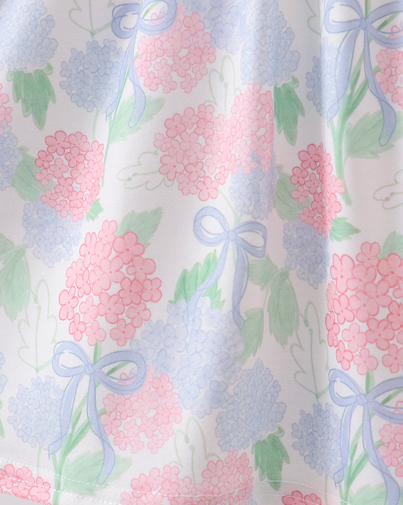 Blue and pink hydrangea floral dress with bow print, skirt close-up view