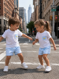White and blue kids shorts set with lemon embroidered pocket tee, city lifestyle view