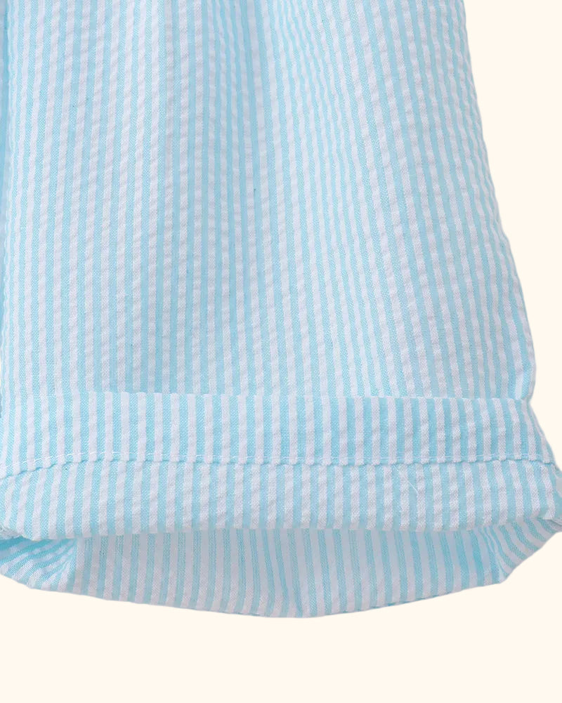 Blue and white striped kids shorts with soft ruffle hem, close-up view