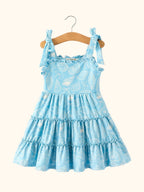 Blue kids seashell tie-shoulder dress with ruffle neckline and tiered skirt, front hanging view