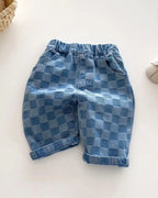 Blue checker plaid kids tapered trousers with elastic waist and rolled cuffs, front view