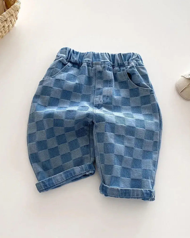 Blue checker plaid kids tapered trousers with elastic waist and rolled cuffs, front view