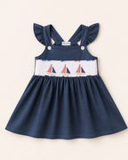 Blue kids smocked top with embroidered sailboats and ruffled straps, front view