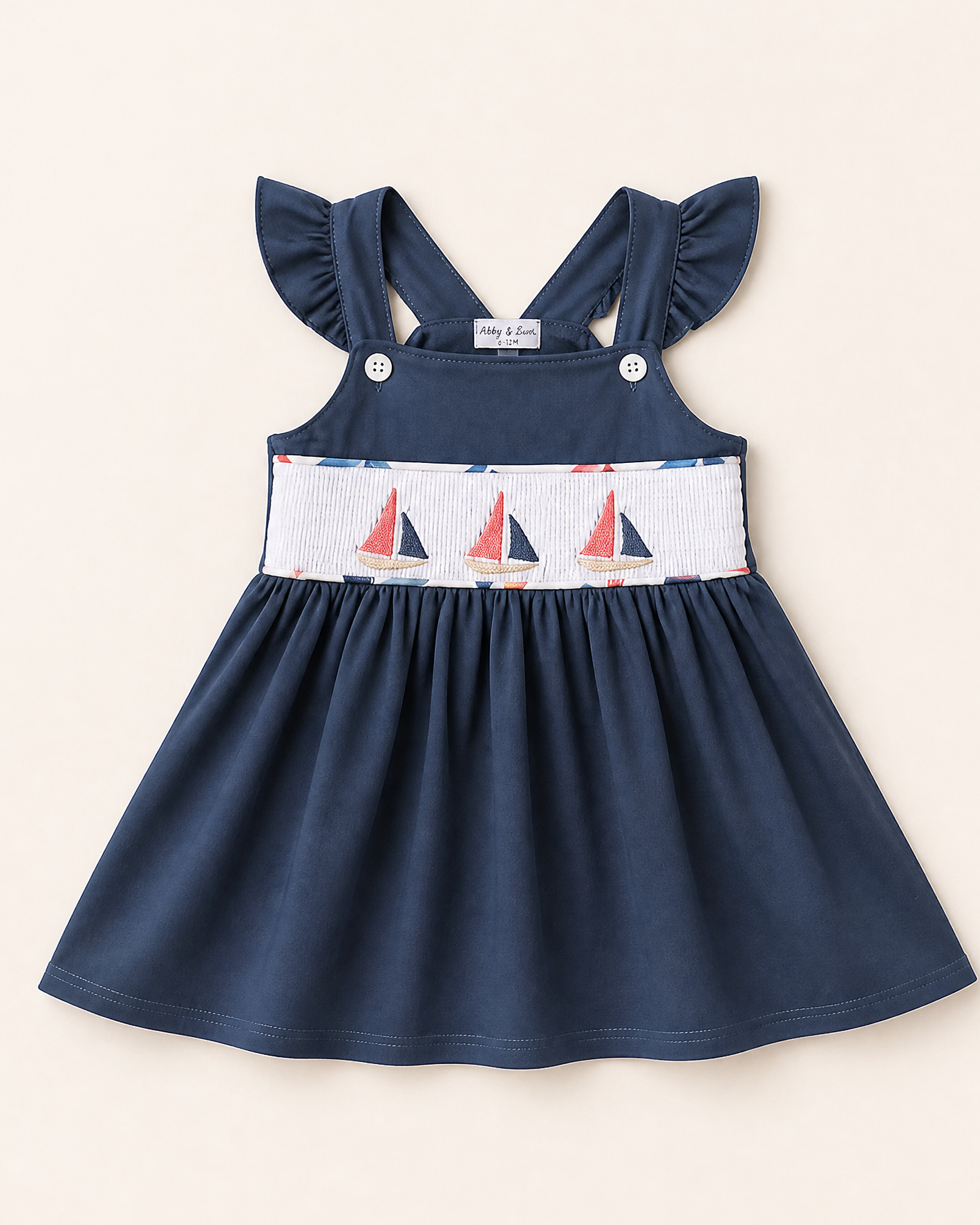 Blue kids smocked top with embroidered sailboats and ruffled straps, front view