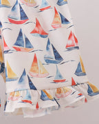 White sailboat print kids shorts with ruffle-trim hem, close-up view