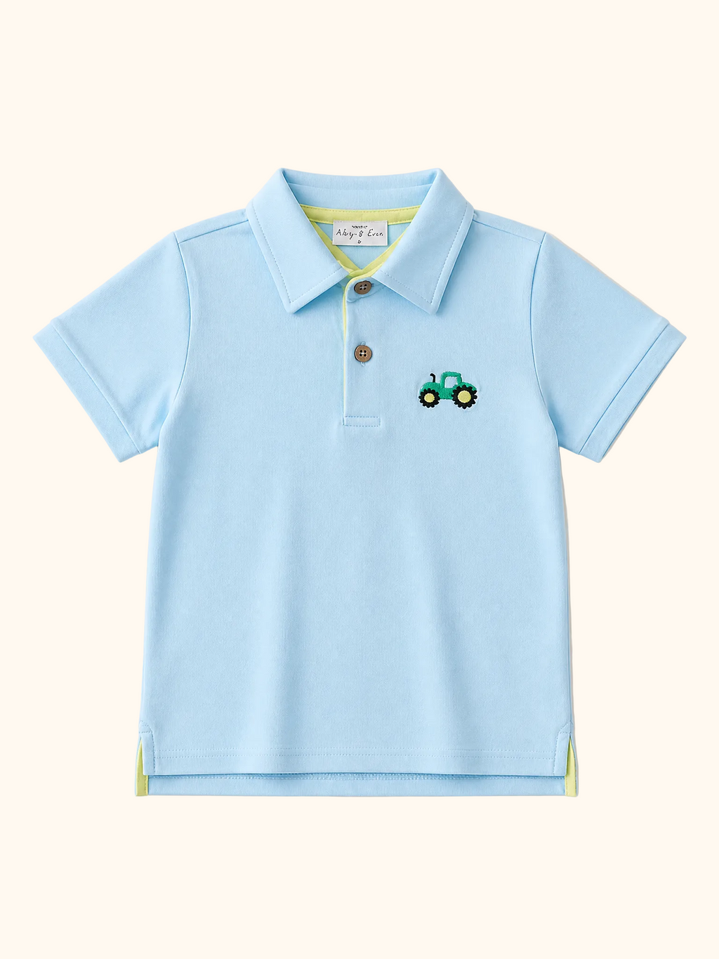 Light blue kids polo shirt with green tractor embroidery and brown button placket, front view