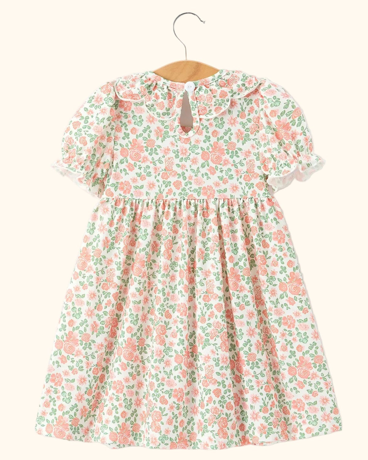 Blush floral kids smocked petal collar dress with puff sleeves and gathered skirt, back hanging view