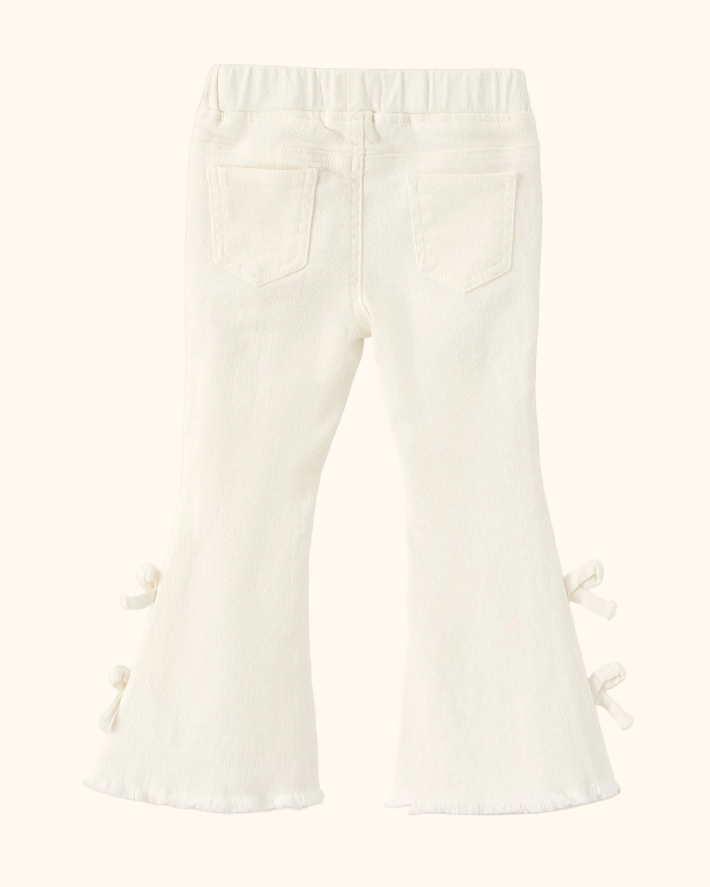 Ivory kids flare denim pants with two back patch pockets and side bow details, back product view
