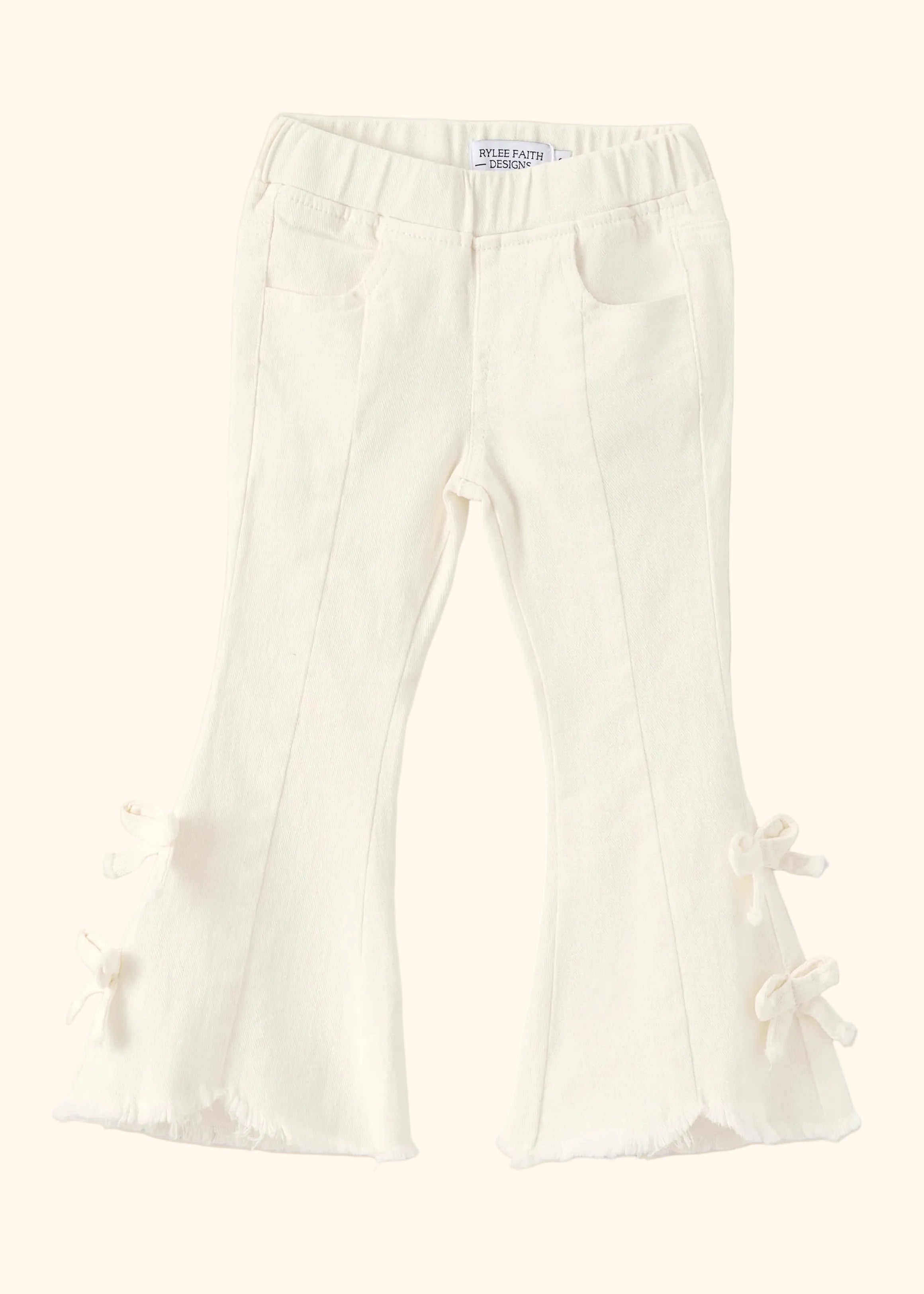 Ivory kids flare denim pants with four side bows and raw-edge hems, front product view