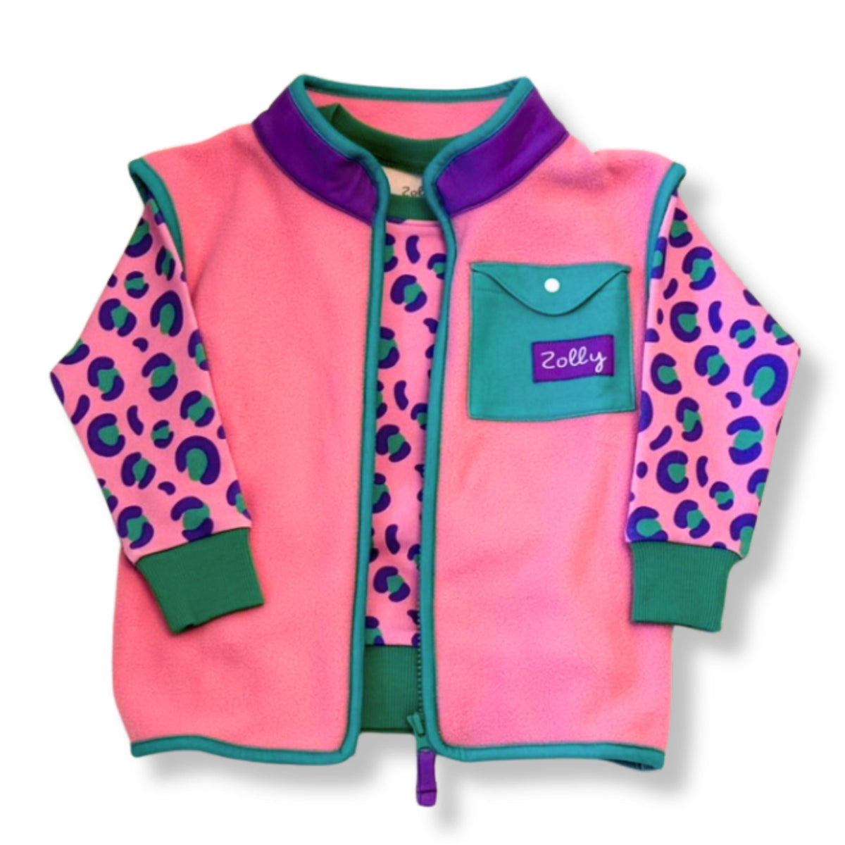Bubblegum pink kids fleece vest with teal trim layered over leopard print long-sleeve top, flat-lay front view