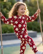 Burgundy floral kids crew neck jogger set with white flowers and green leaves, lifestyle front view