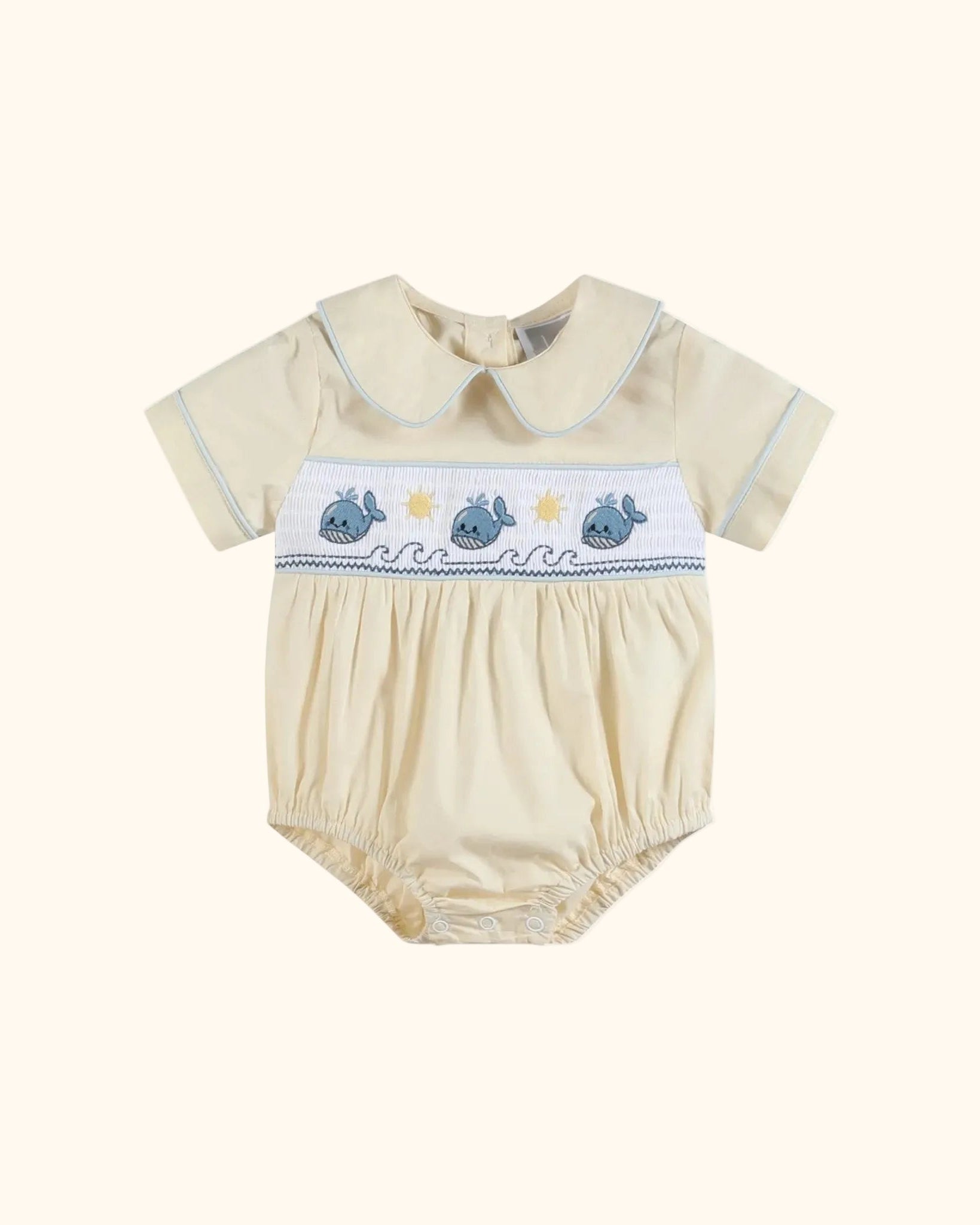 Buttercream yellow baby whale smocked romper with blue-trimmed collar, front product view
