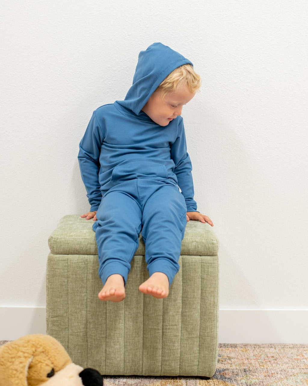 Captain blue kids hooded pocket jogger set with cuffed pants, seated front lifestyle view
