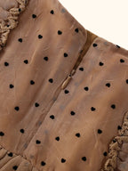 Caramel polka dot ruffle dress with back zipper closure, close-up back view