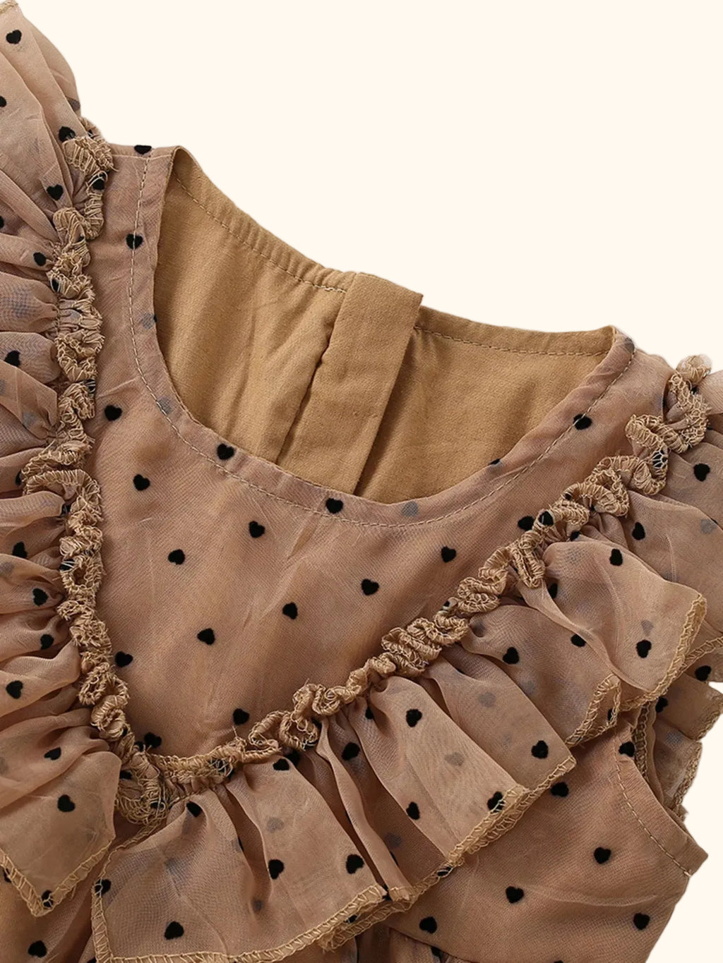 Caramel kids polka dot ruffle dress with sheer dotted ruffle neckline, close-up front detail