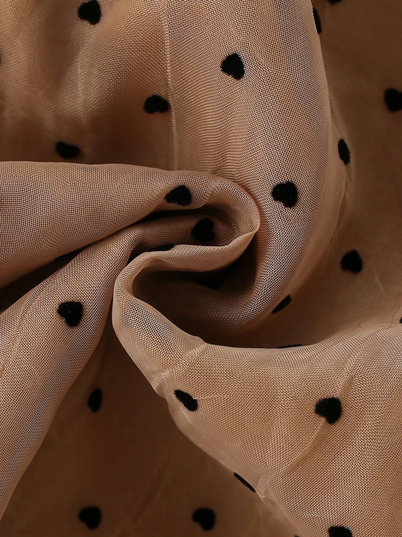 Caramel sheer dress fabric with black polka dots, fabric detail view