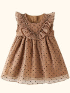 Caramel kids polka dot ruffle dress with gathered skirt and black dots, flat lay front view