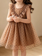 Caramel kids polka dot ruffle dress with layered front ruffles, modeled front view