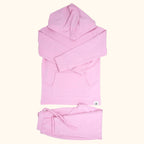 Carnation pink hooded top with kangaroo pocket and matching kids joggers, flat lay front view