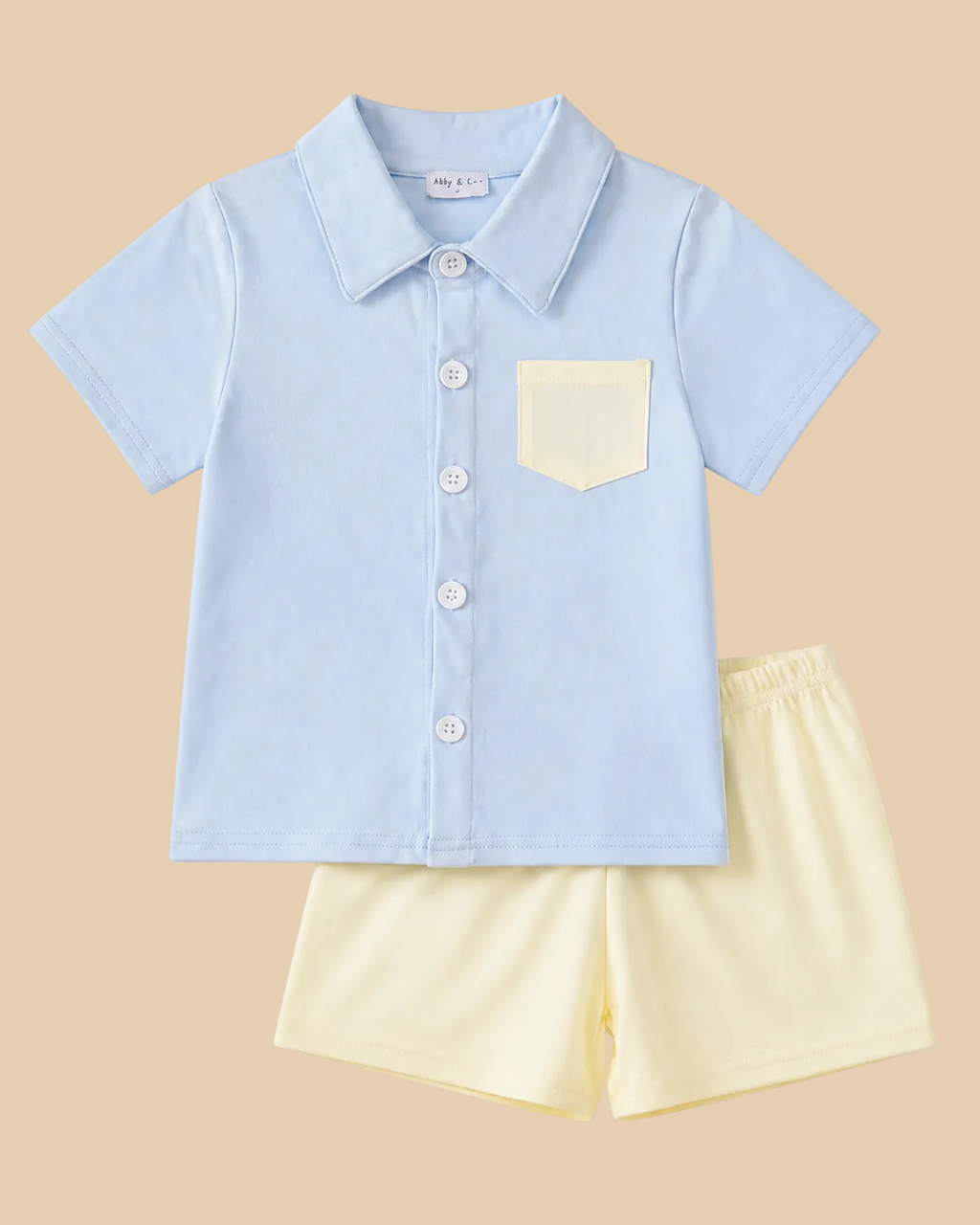 Powder blue kids button-up shirt and cream shorts set with contrast chest pocket, front product view