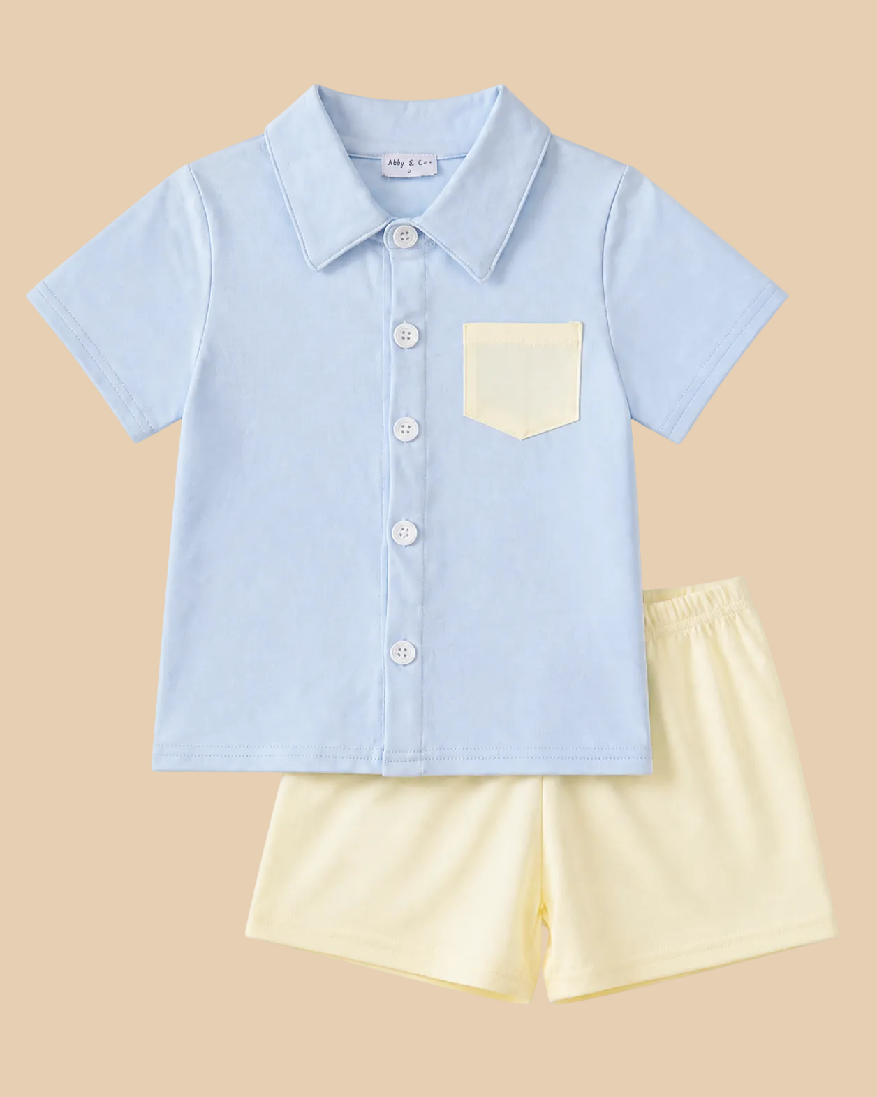 Powder blue kids button-up shirt and cream shorts set with contrast chest pocket, front product view