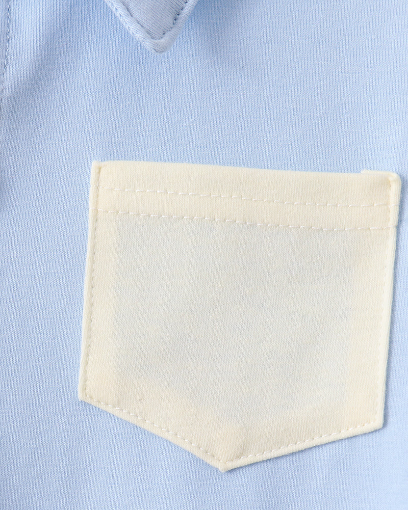 Powder blue kids collared shirt with cream contrast patch pocket, close-up view